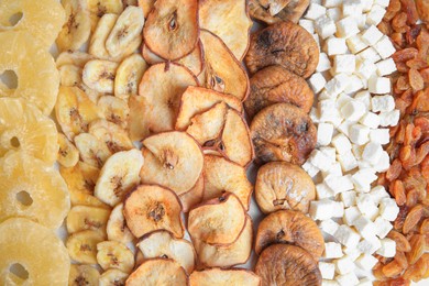 Different tasty dried fruits as background, top view