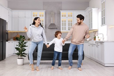 Happy family dancing and having fun at home