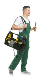 Photo of Young plumber with tool bag on white background