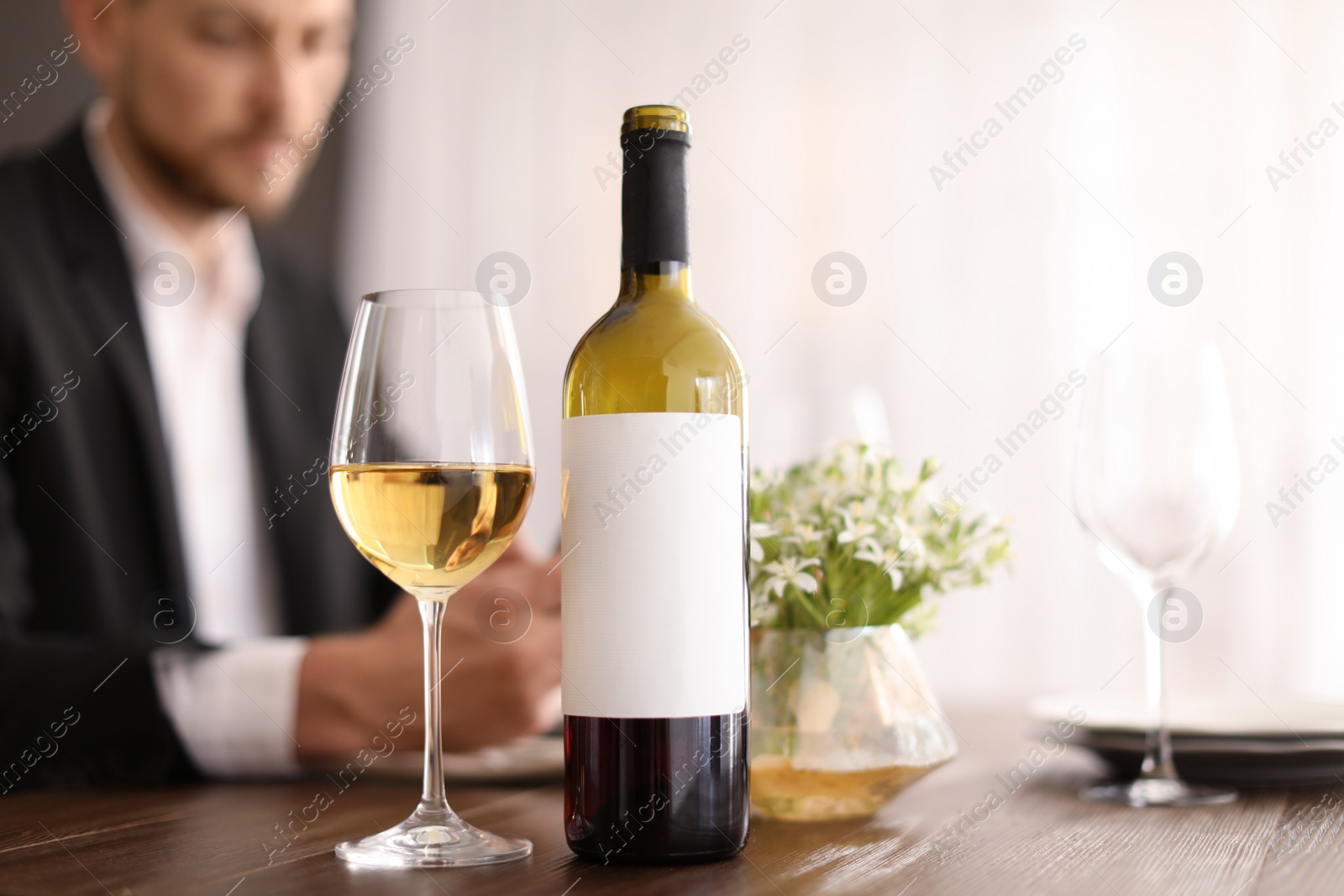 Photo of Man with glass of wine at table in restaurant