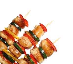 Delicious chicken shish kebabs with vegetables on white background