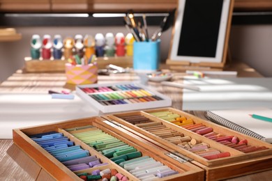 Photo of Artist's workplace with soft pastels on table