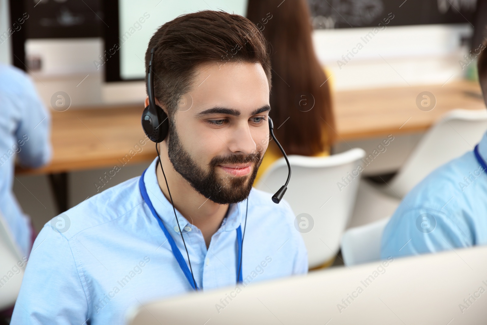 Photo of Technical support operator working with colleagues in office