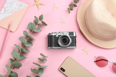 Photo of Flat lay composition with camera for professional photographer and smartphone on pink background