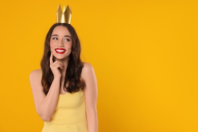 Photo of Beautiful young woman with princess crown on yellow background, space for text