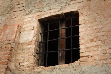 Exterior view of old building with grated window