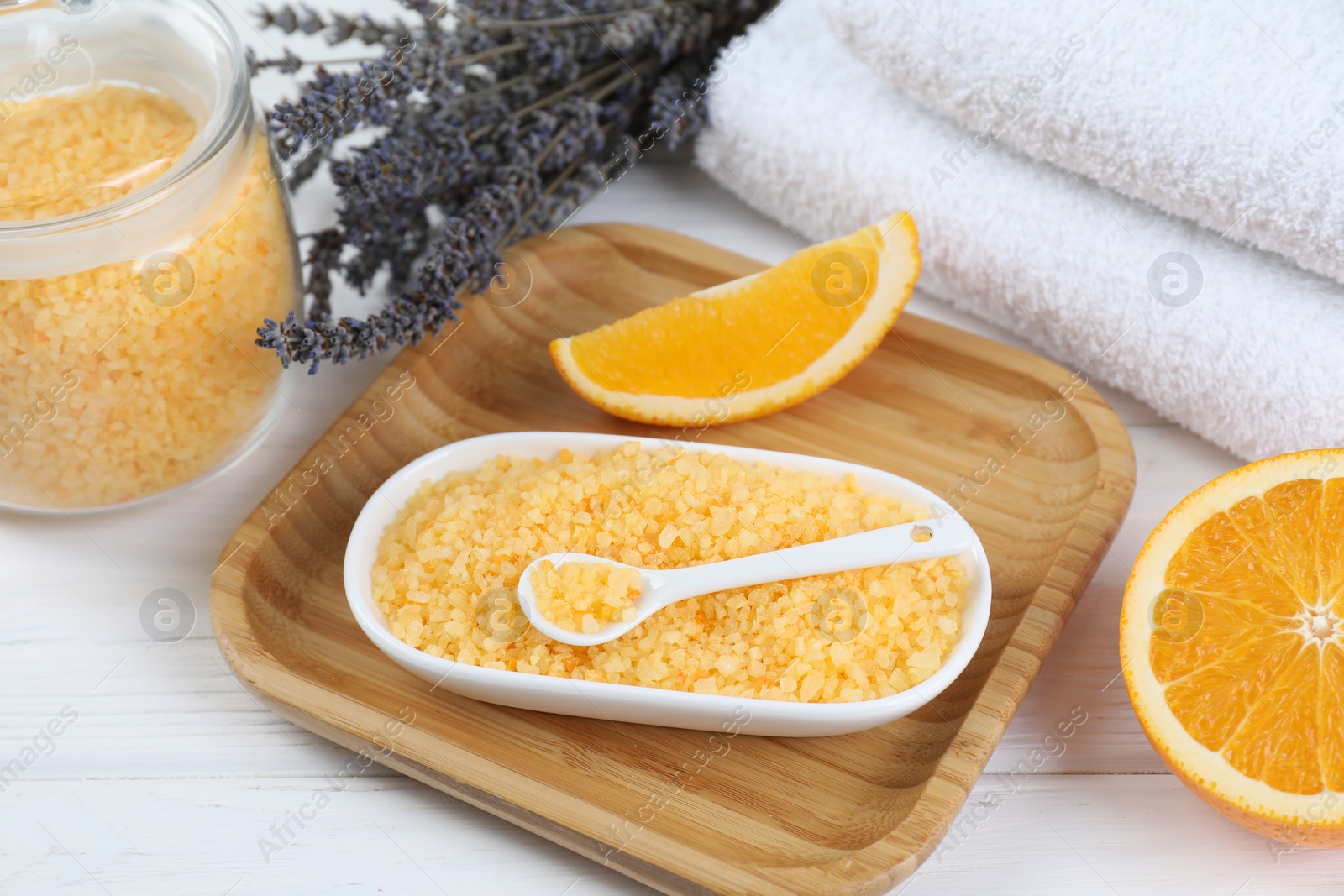 Photo of Sea salt, lavender, orange and towels on white wooden table