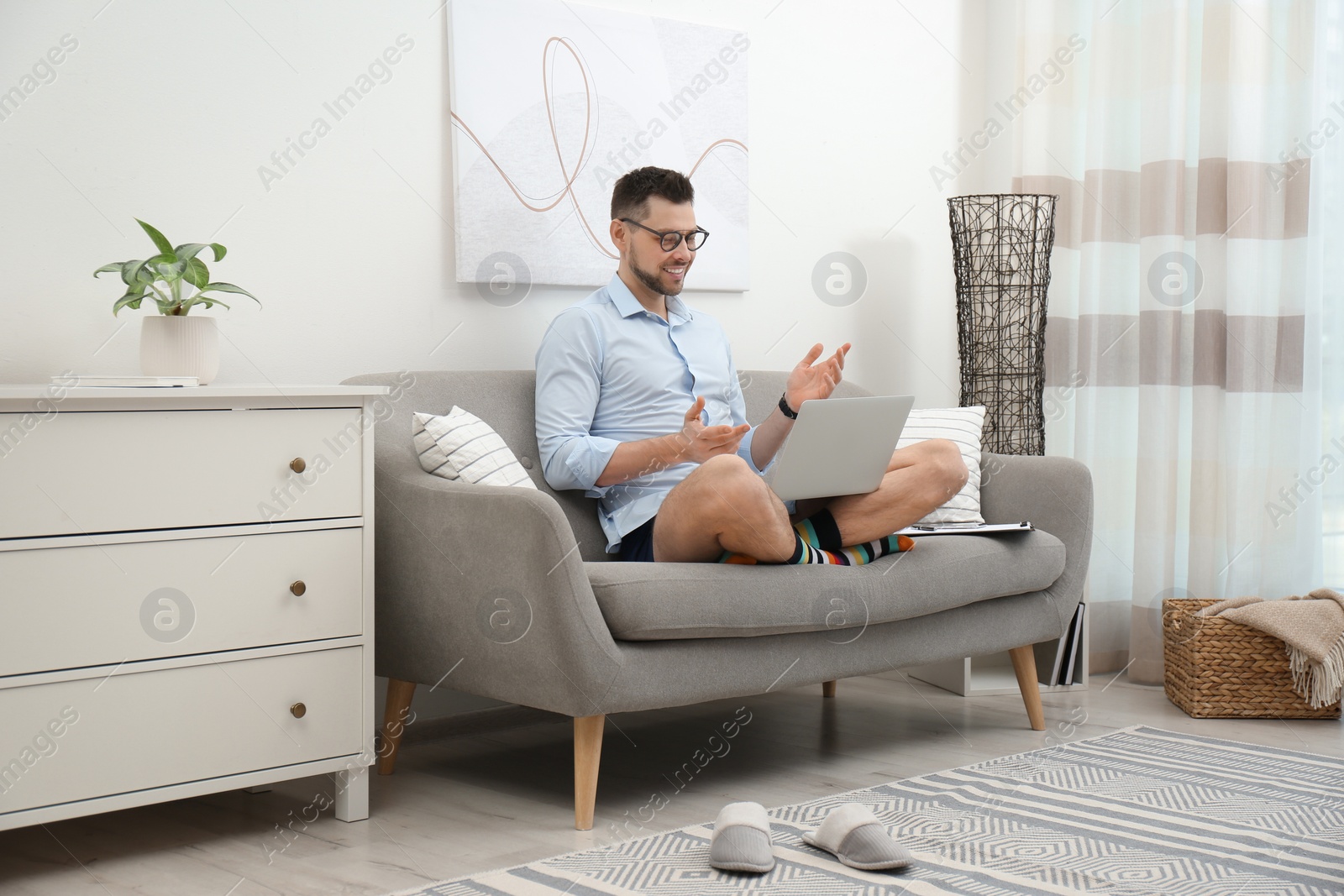 Photo of Businessman in underwear pretending to wear formal clothes during video call at home