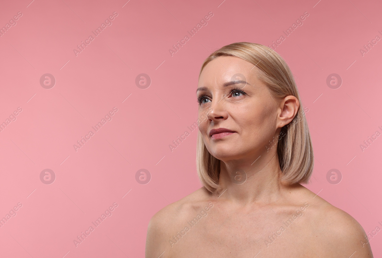 Photo of Beautiful woman with healthy skin on pink background. Space for text