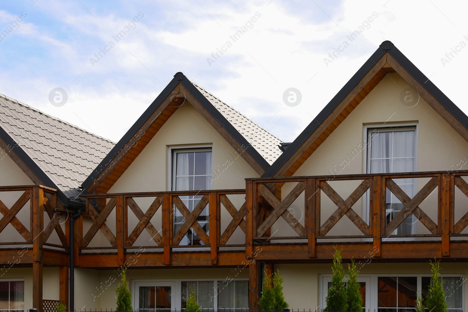 Photo of Exterior of beautiful modern houses against cloudy sky