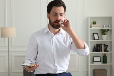 Man with cigarette and case in office