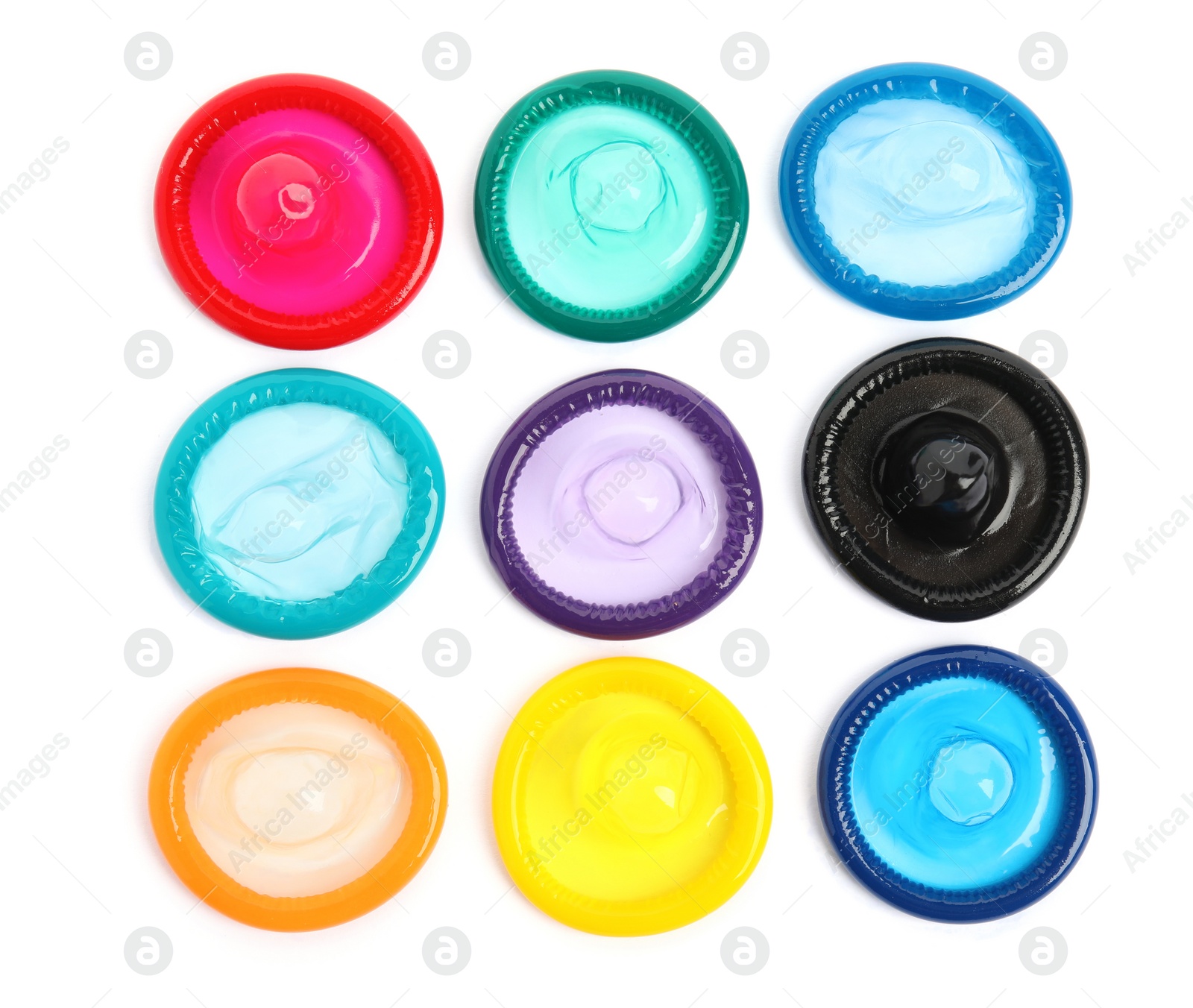 Photo of Unpacked colorful condoms on white background, top view. Safe sex