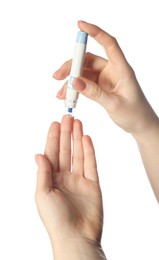 Diabetes. glucose testing. Woman using lancet pen on white background, closeup