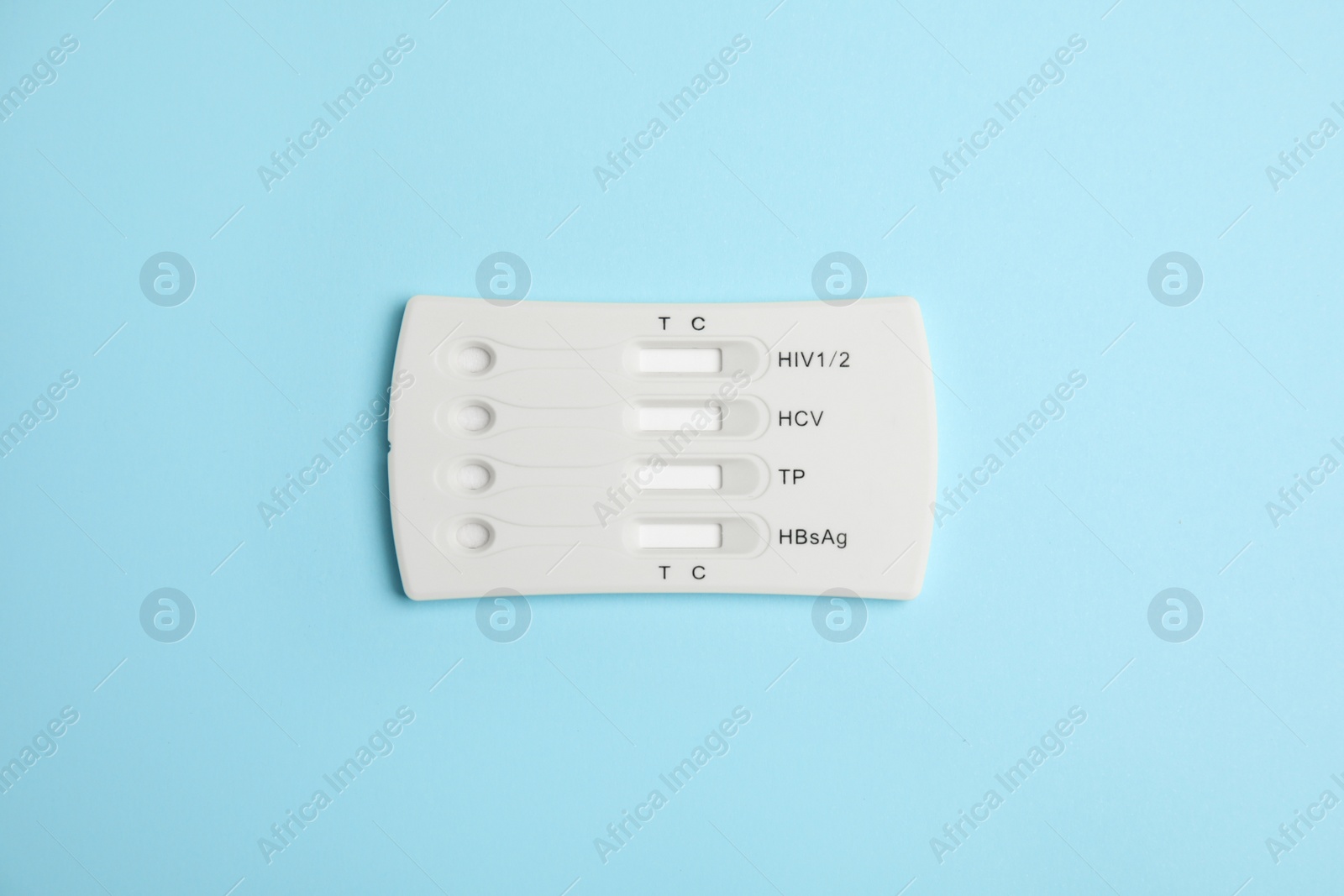 Photo of One disposable express test for hepatitis on light blue background, top view