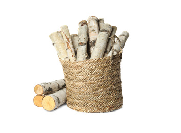 Photo of Wicker basket with cut firewood isolated on white