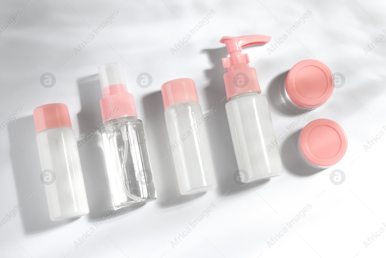 Photo of Cosmetic travel kit on white background, top view