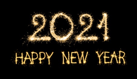 Happy new year card. 2021 and text silhouettes made of sparkler on black background
