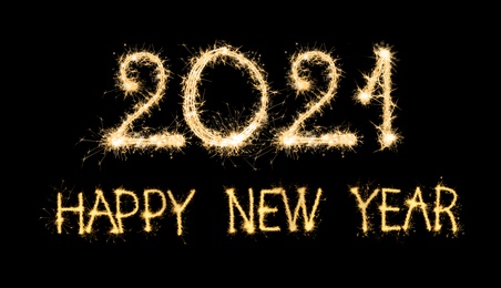 Image of Happy new year card. 2021 and text silhouettes made of sparkler on black background