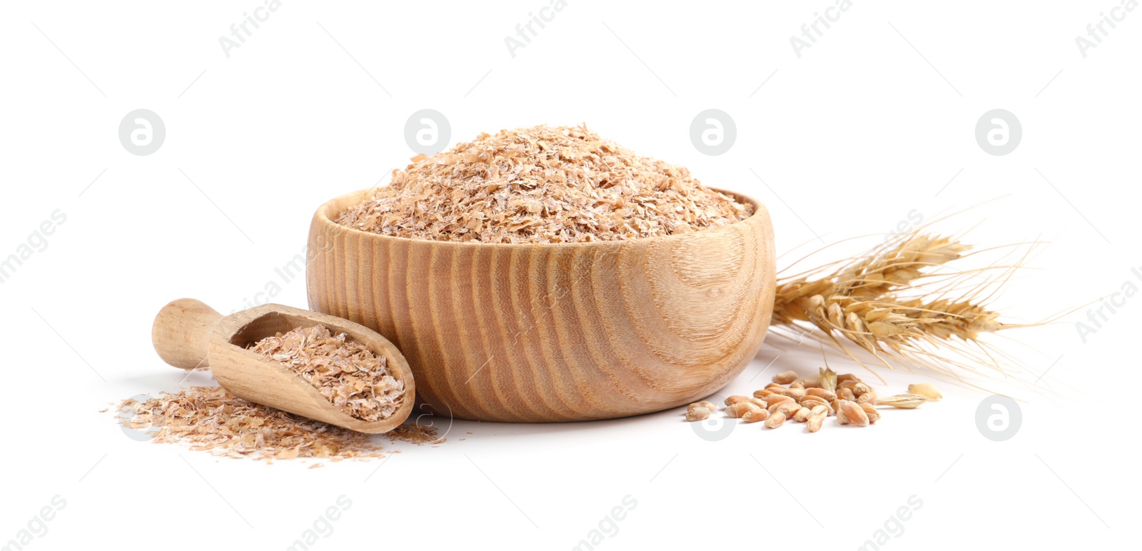 Photo of Wooden bowl and scoop with wheat bran on white background