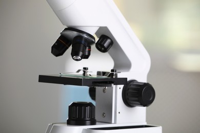Photo of Modern medical microscope on blurred background, closeup. Laboratory equipment