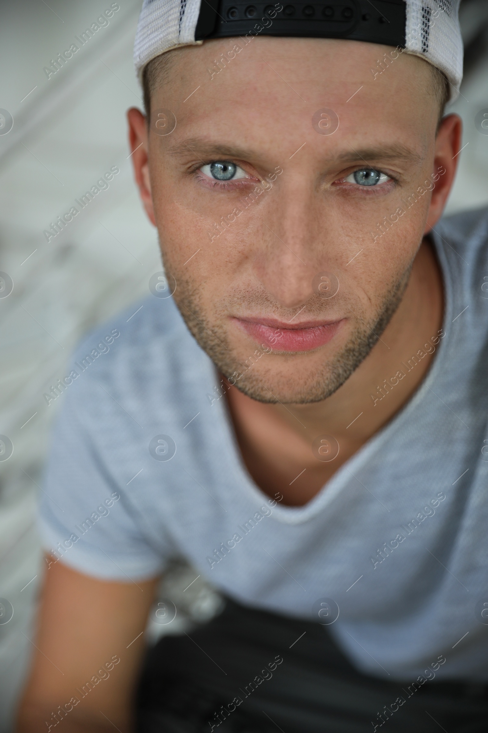 Photo of Portrait of handsome young man in stylish cap, closeup