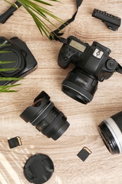 Photo of Professional photographer's equipment on wooden table, top view