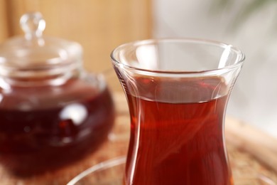 Traditional Turkish tea in glass on table, closeup. Space for text