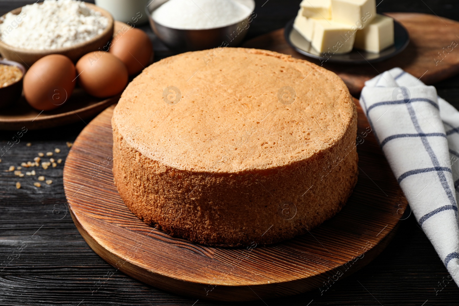 Photo of Delicious fresh homemade cake on black wooden table