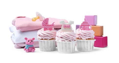 Photo of Beautifully decorated baby shower cupcakes for girl, clothes and toys on white background