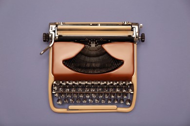 Vintage typewriter on grey background, top view