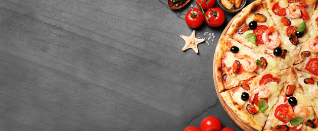 Image of Top viewhot delicious pizza on dark table, space for text. Banner design 