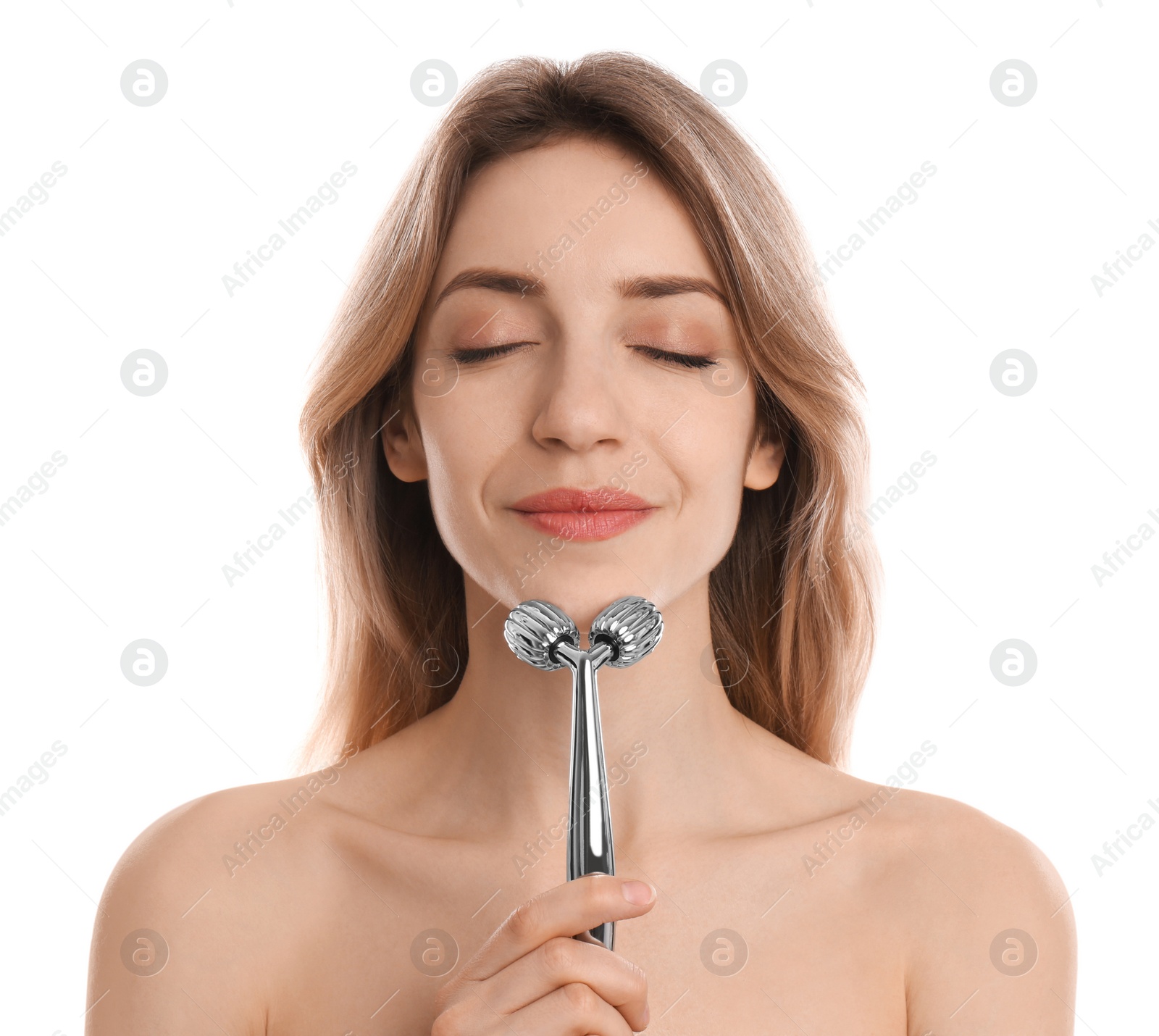 Photo of Young woman using metal face roller on white background