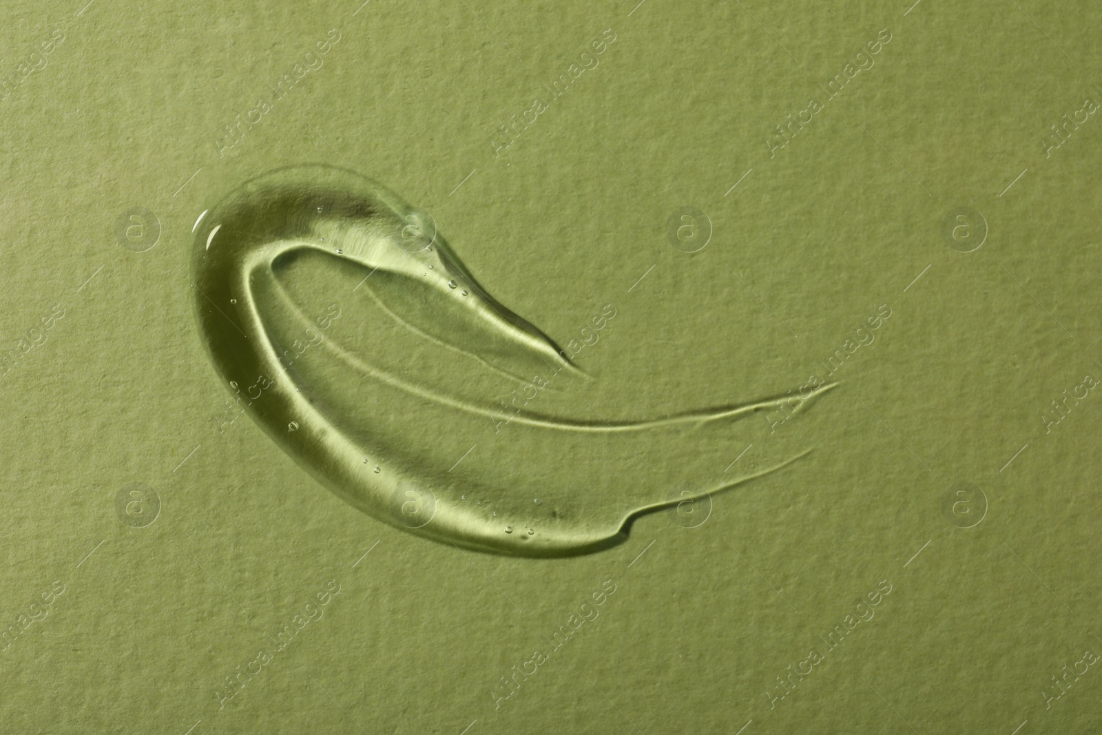 Photo of Sample of cosmetic gel on green background, top view