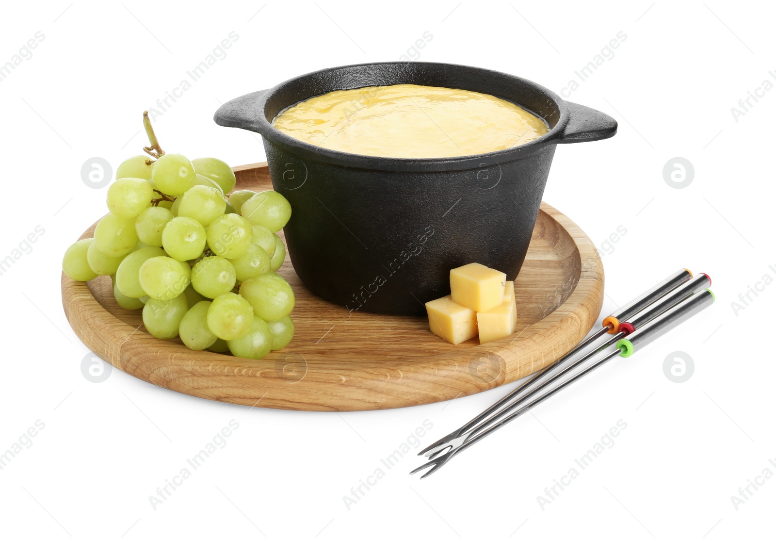 Photo of Fondue with tasty melted cheese, forks and grapes isolated on white
