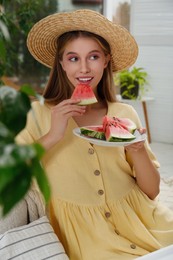 Photo of Beautiful teenage girl eating watermelon at home