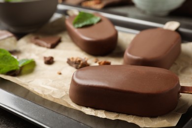 Glazed ice cream bars on baking tray, closeup