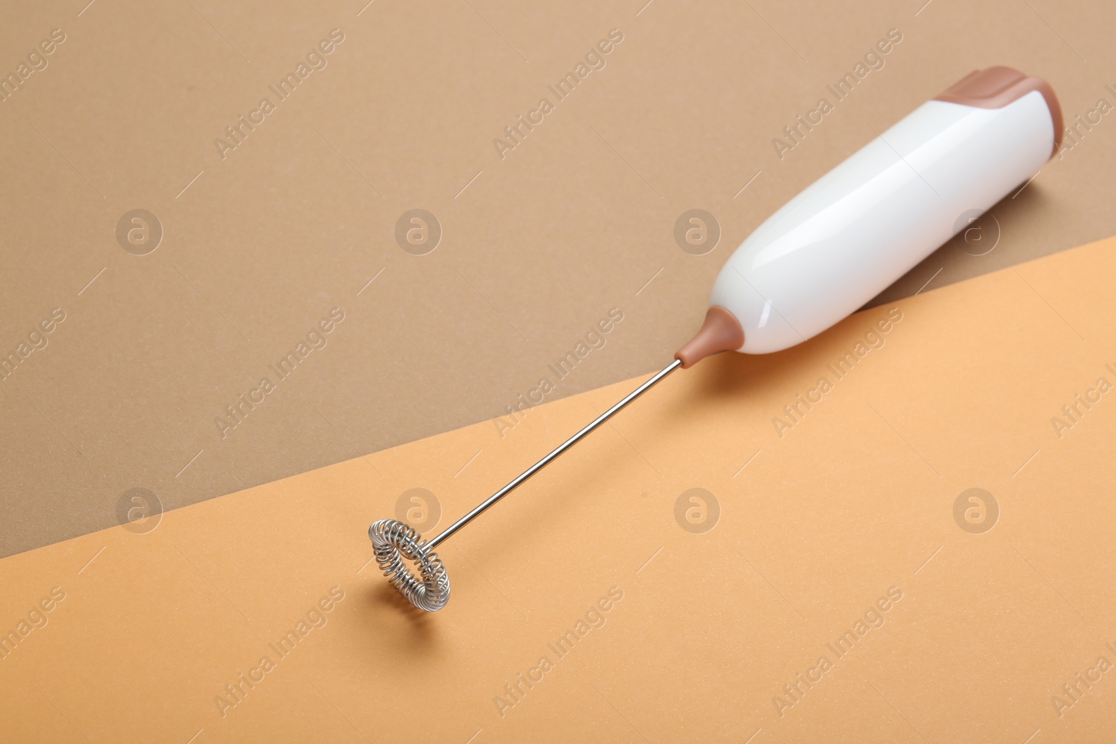 Photo of White milk frother wand on color background, space for text