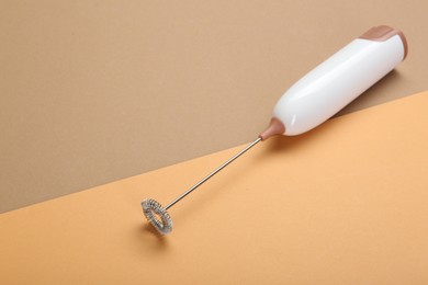 White milk frother wand on color background, space for text