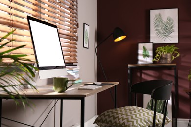 Photo of Comfortable workplace with modern computer and stylish furniture in room. Interior design