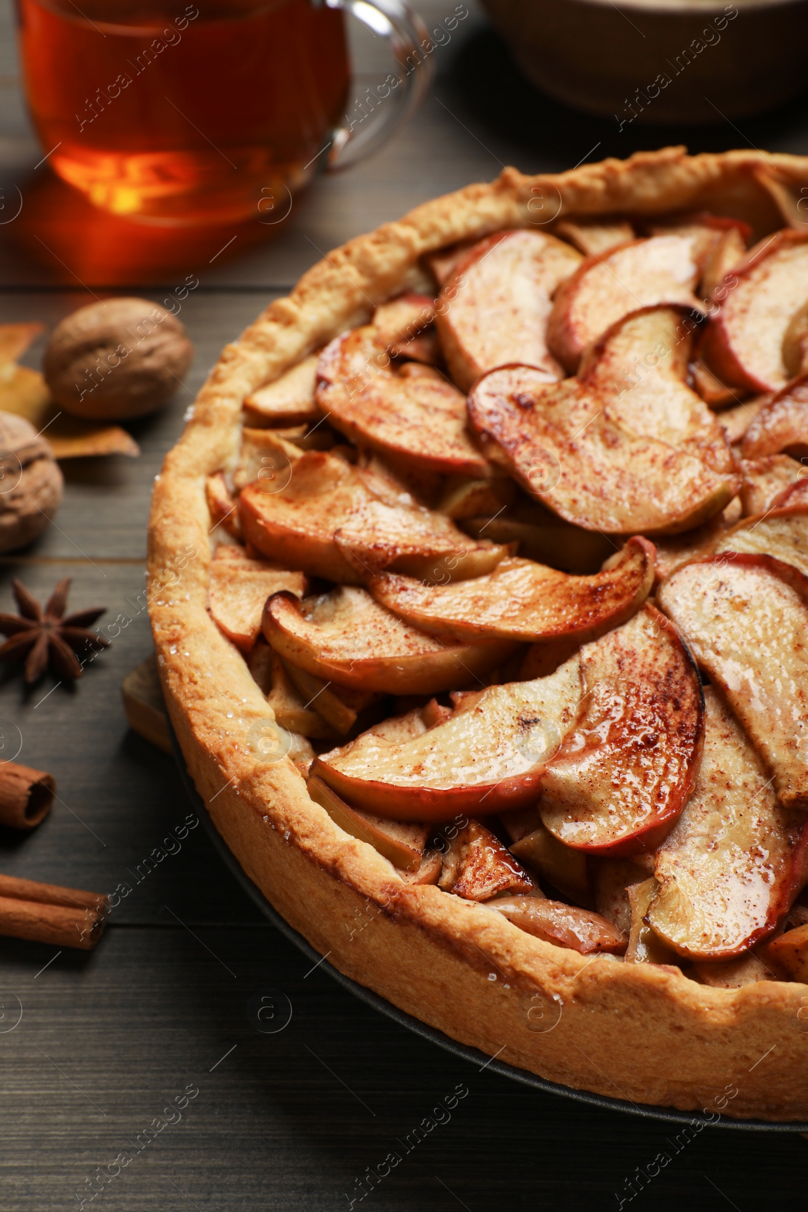 Photo of Delicious apple pie on wooden table, closeup