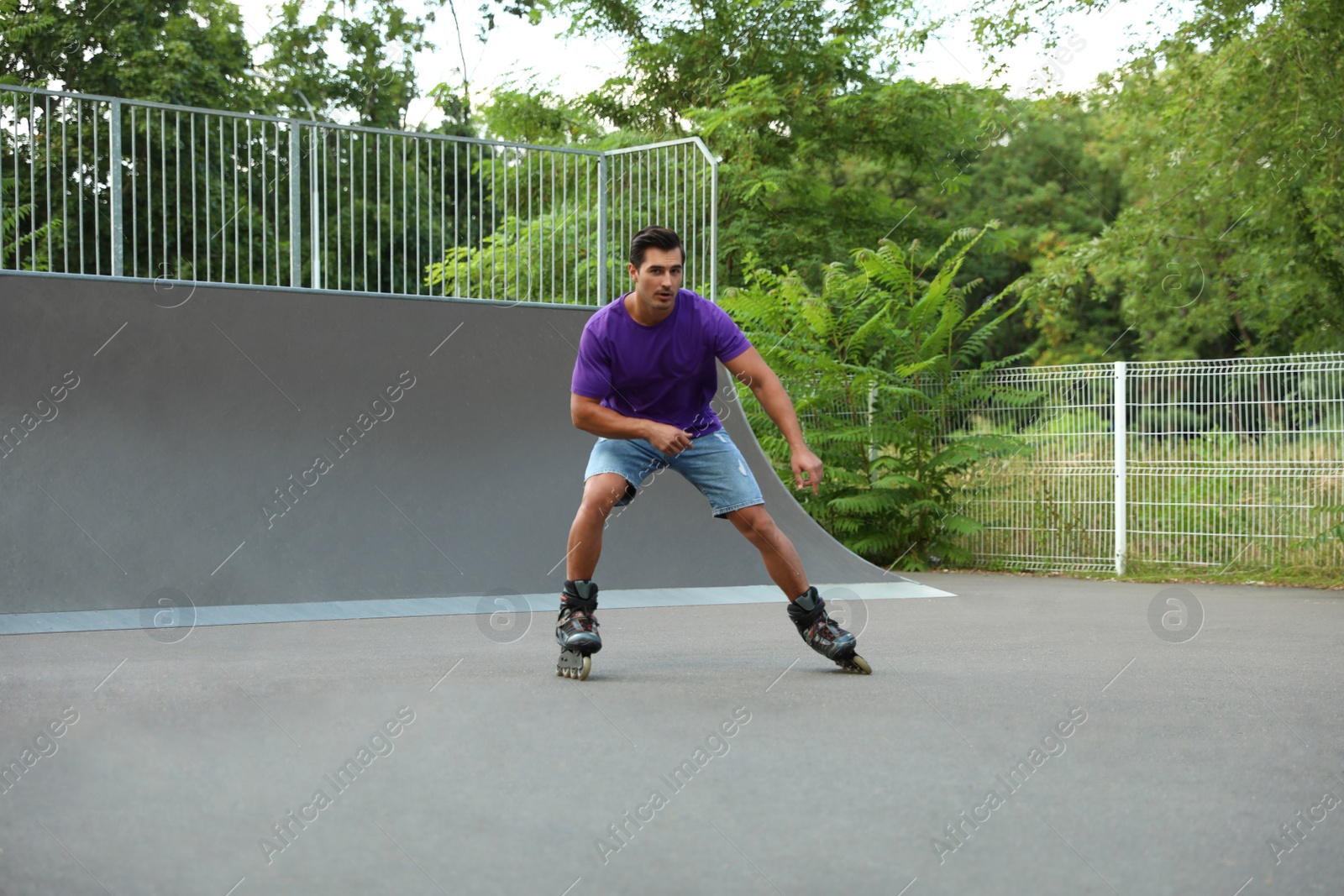 Photo of Handsome young man roller skating in park