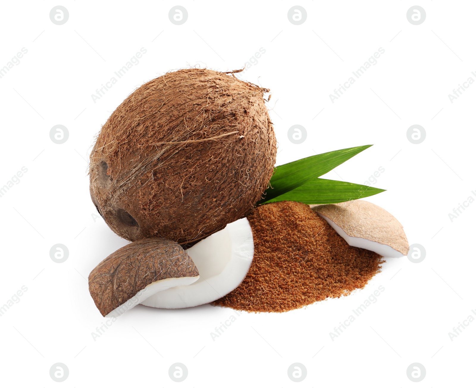 Photo of Ripe coconuts and pile of brown sugar on white background