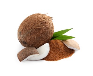 Photo of Ripe coconuts and pile of brown sugar on white background