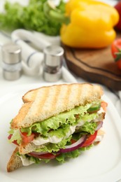 Photo of Delicious sandwich with vegetables and cheese on plate, closeup