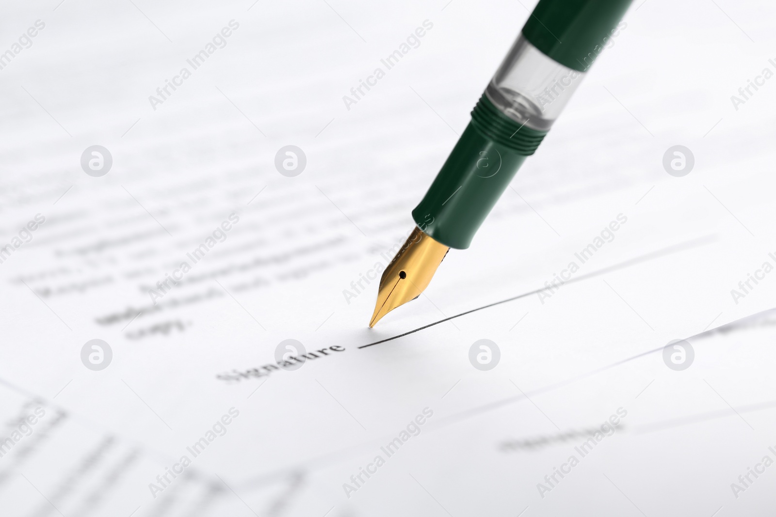 Photo of Signing notary document with fountain pen, closeup