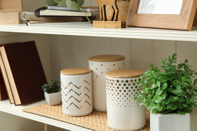 Photo of White shelving unit with different decorative elements