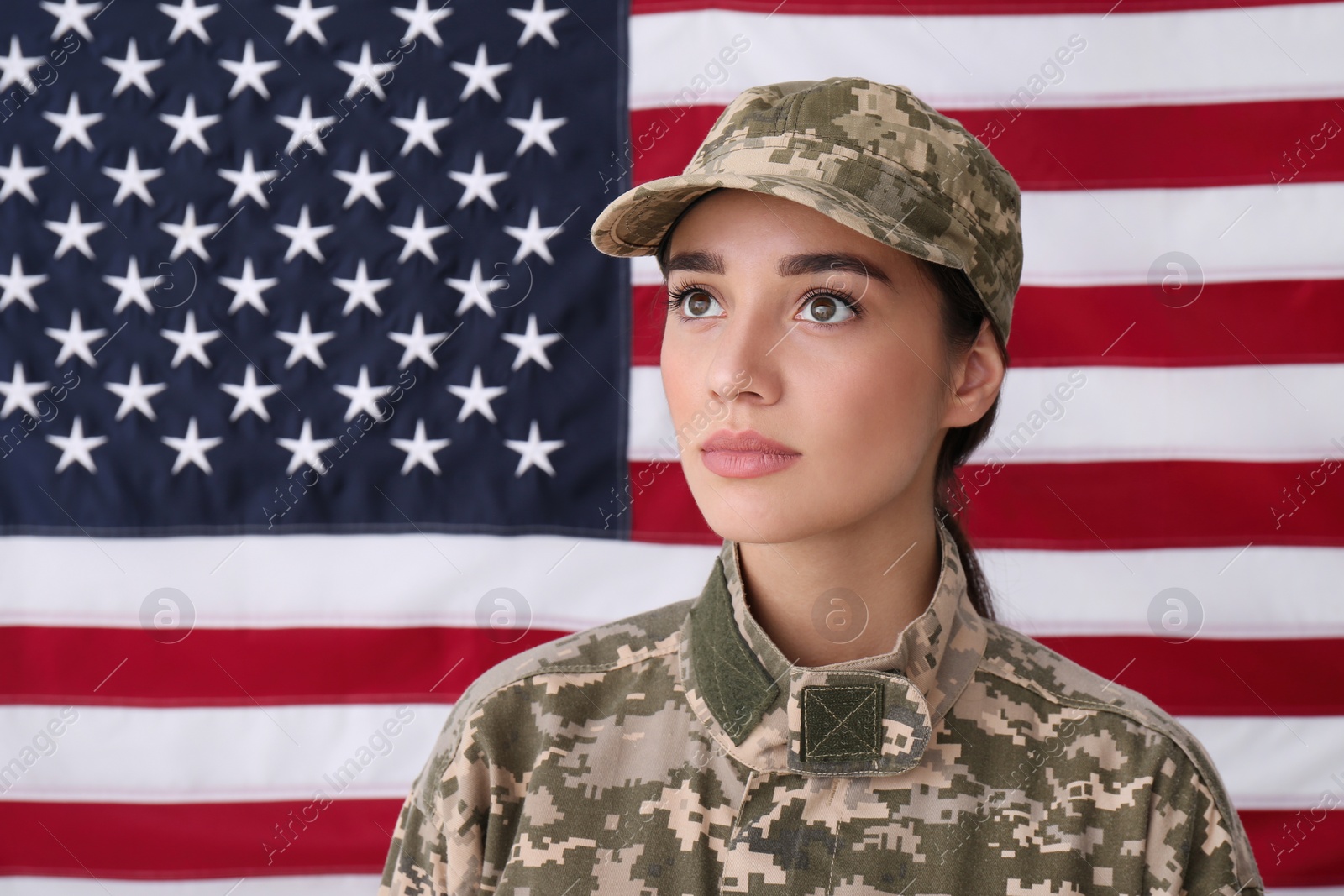 Photo of Female soldier in uniform against United states of America flag