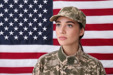 Photo of Female soldier in uniform against United states of America flag