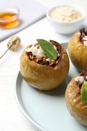 Photo of Sweet baked apple on white wooden table