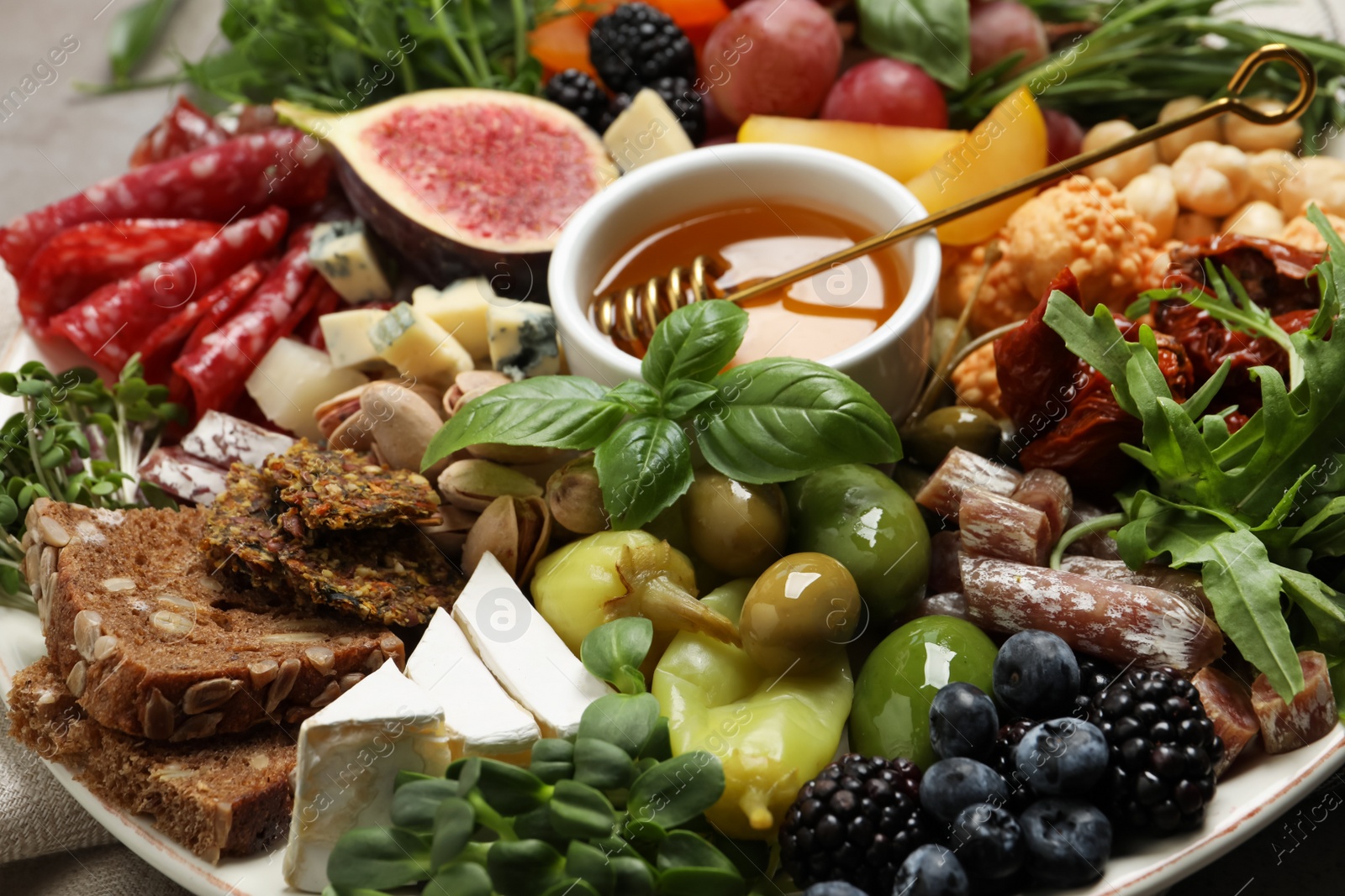 Photo of Set of different delicious appetizers on plate, closeup